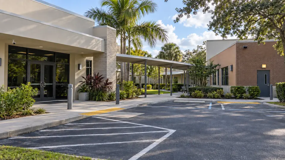 Illustrative educational campus entrance connecting administration, parking and controlled staff access.